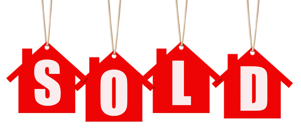 Four house figures hanging by string with the letters S-O-L-D in each little red house.